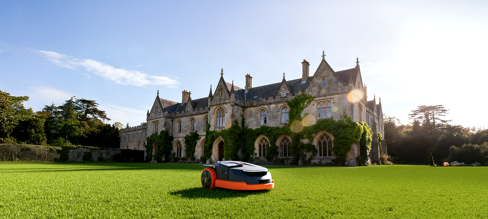 Navimow i105E robot lawn mower on a large sunny lawn.