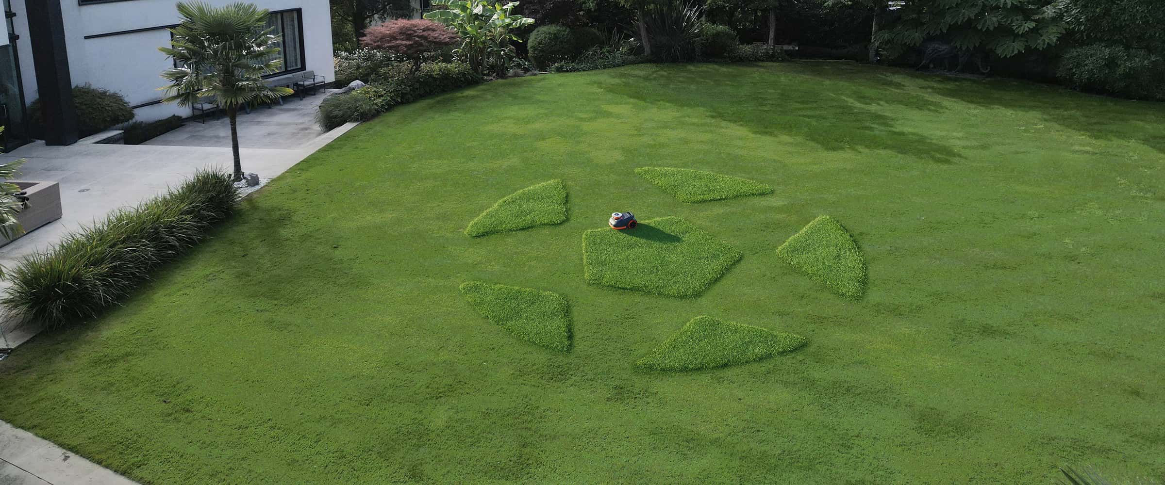 Navimow i110E robot lawn mower mows a soccer ball pattern.