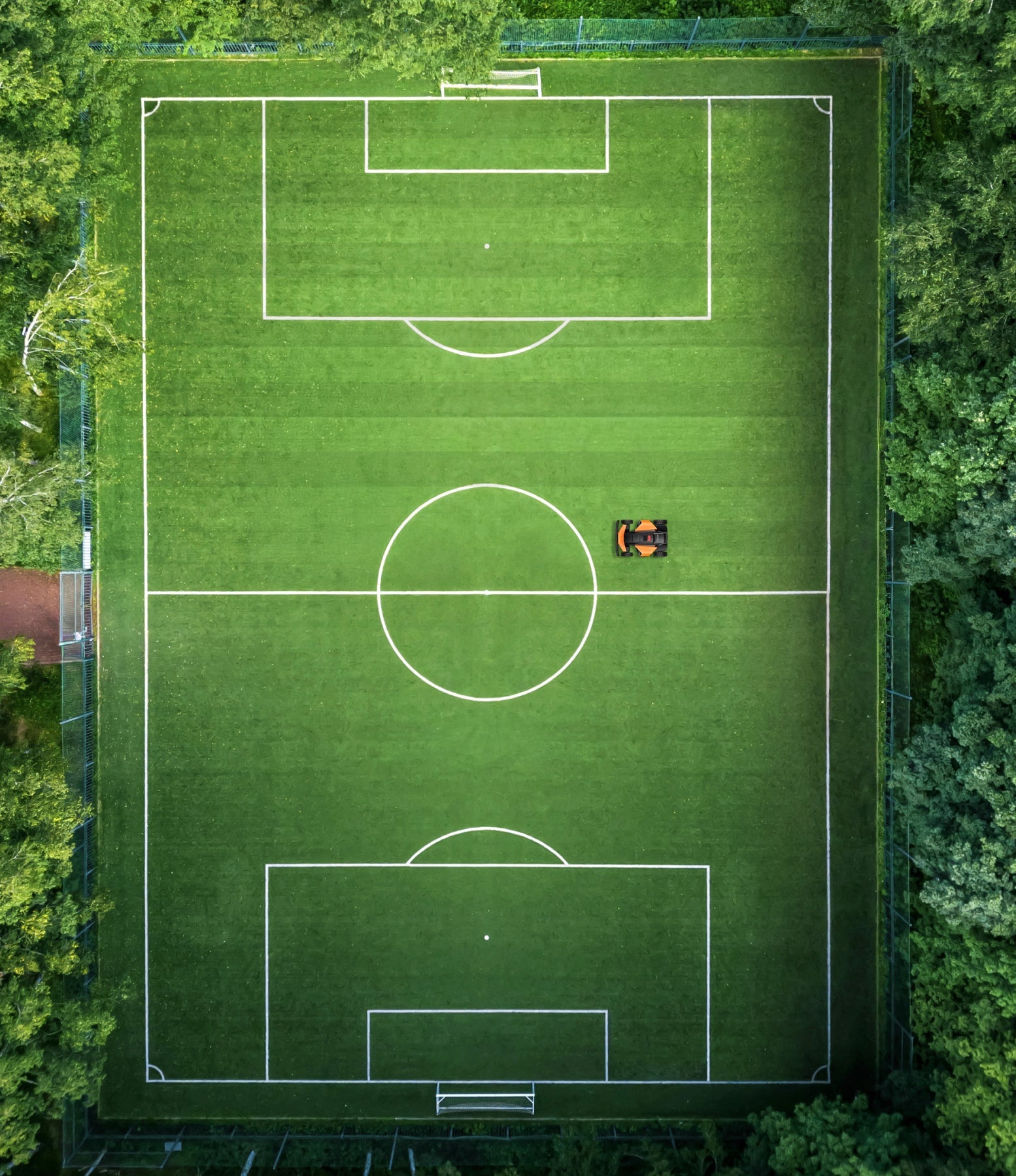 Segway Navimow i110N robot lawn mower on a soccer field.