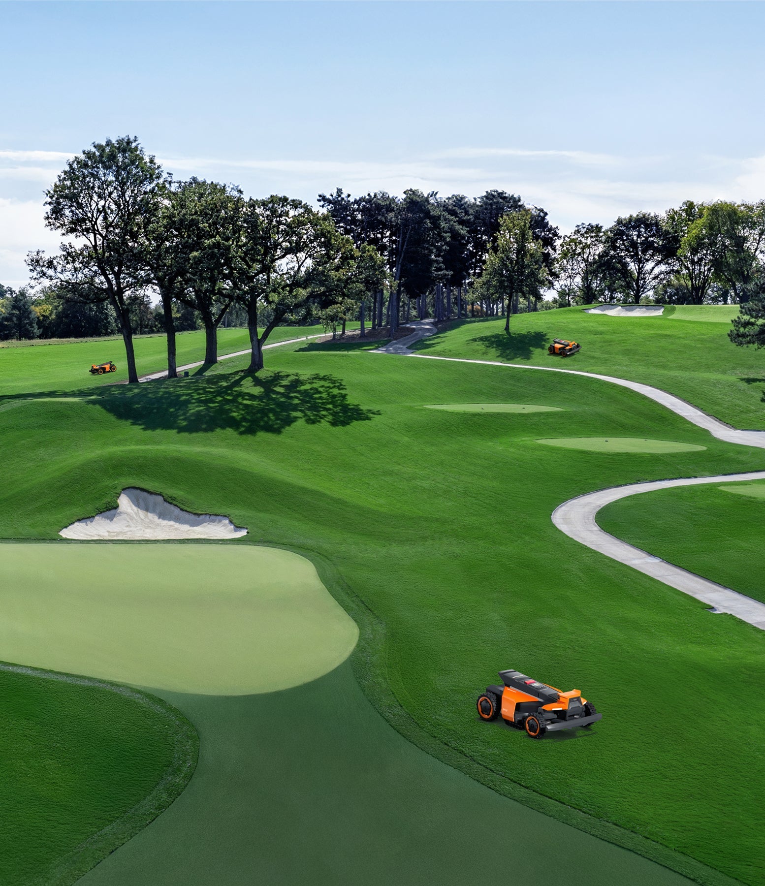 Navimow i110E robot lawn mower on a green golf course.