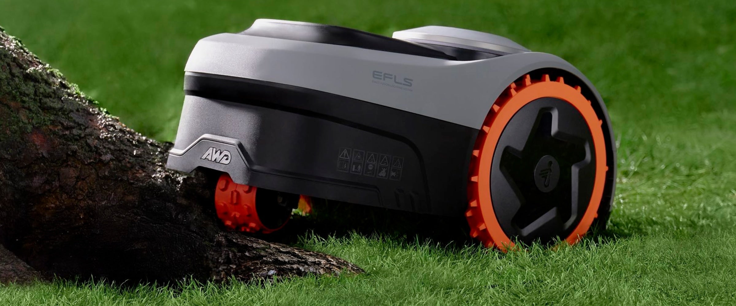 Navimow i110N robot lawn mower climbing over a tree root.