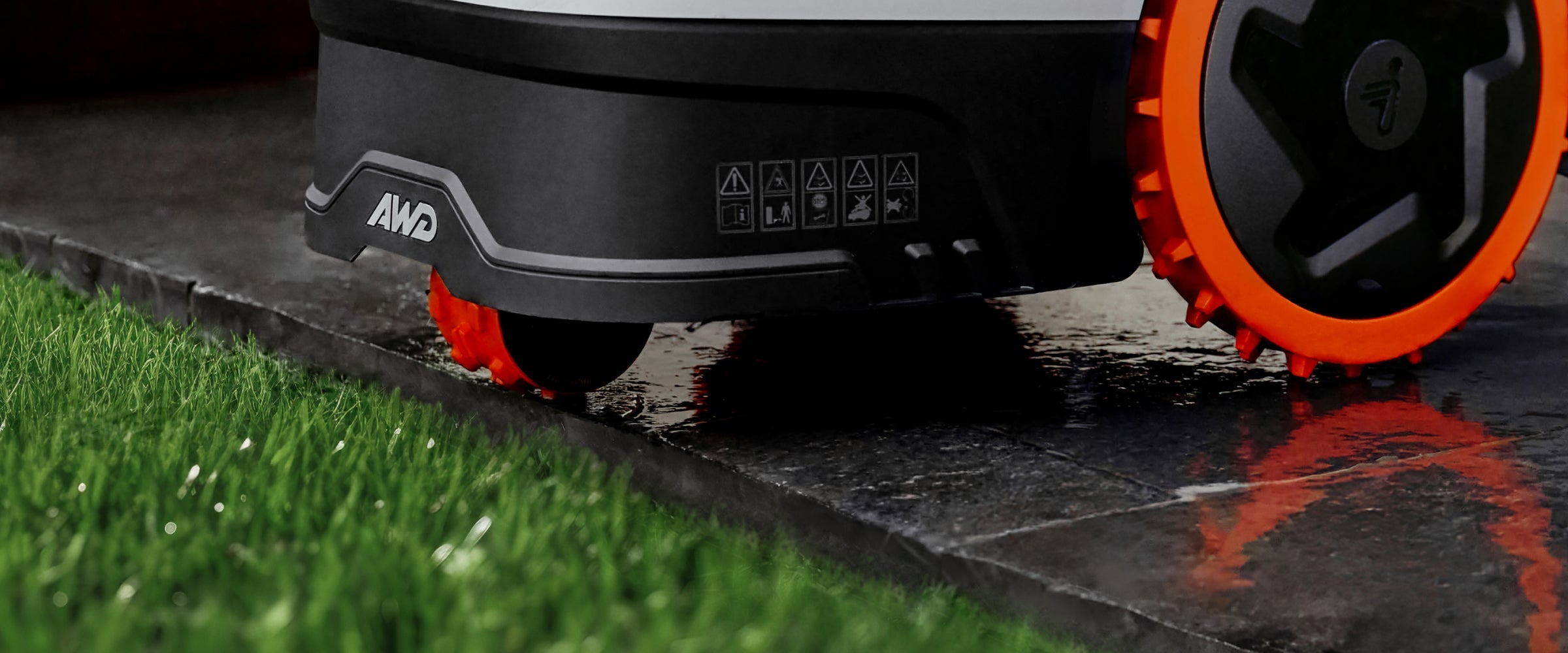 Navimow i110N AWD robot lawn mower on a wet patio.