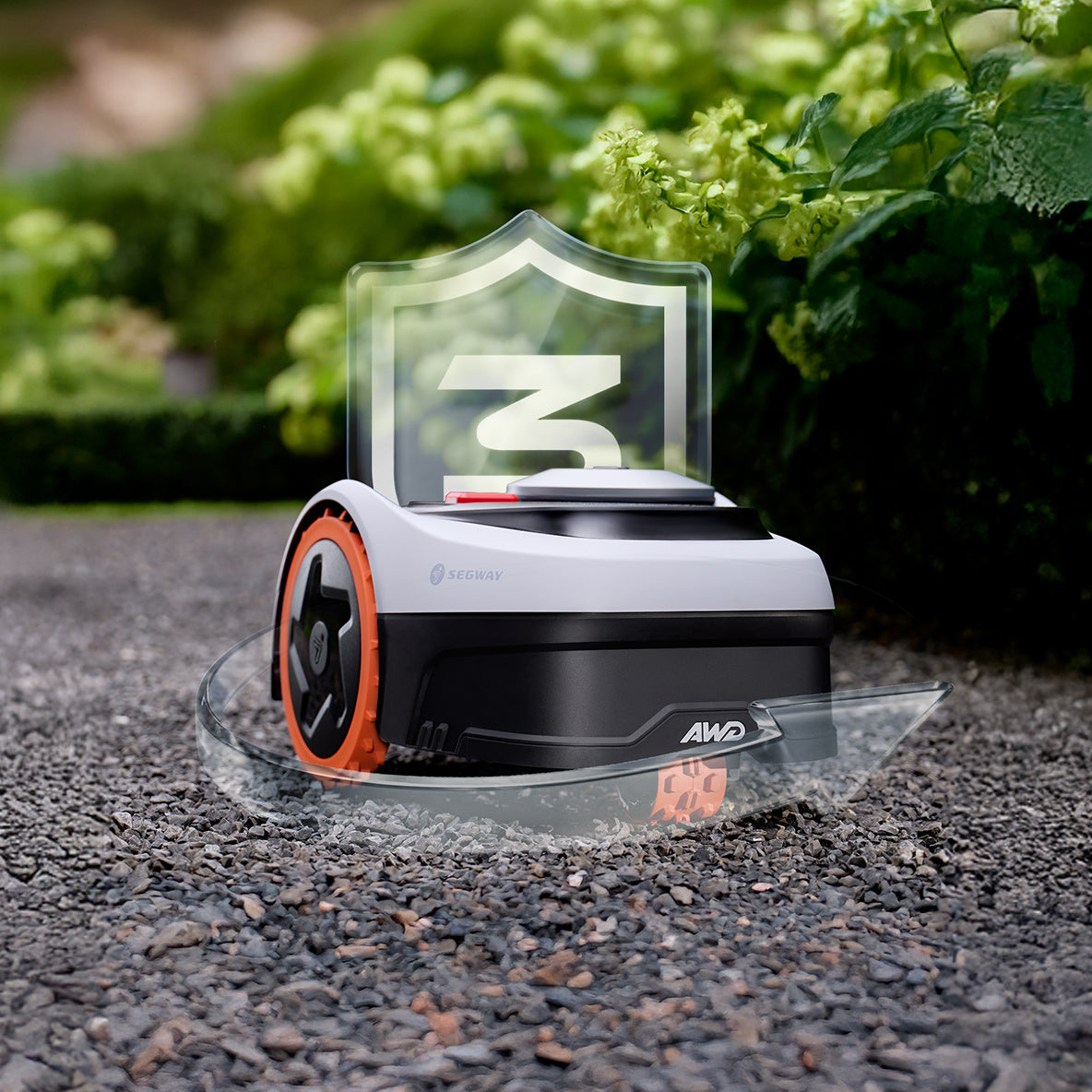 The Segway Navimow X3 robot lawn mower sits on gravel.