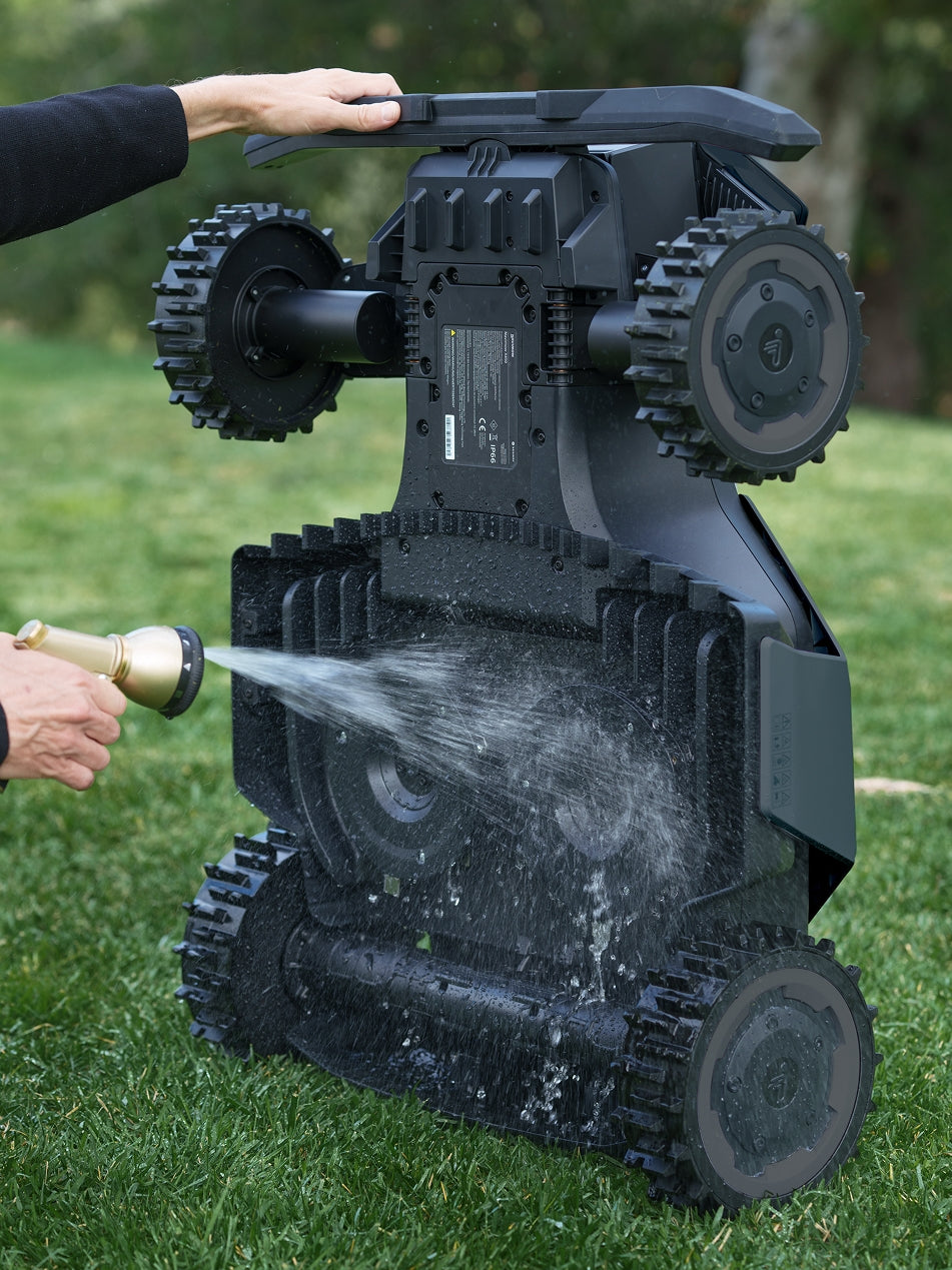 Segway Navimow i105E robot lawn mower being washed with water.