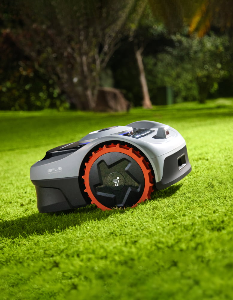 Navimow i110E robot lawn mower sits on the green grass.