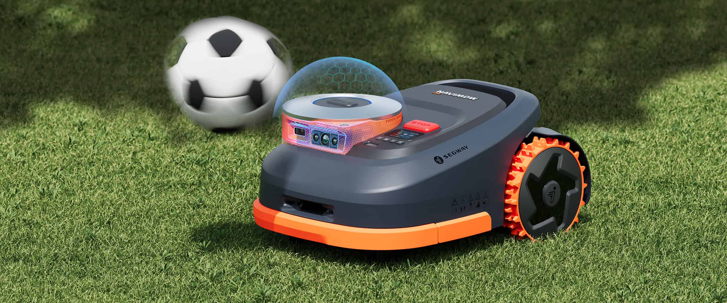 Segway Navimow robot lawn mower mows grass near soccer ball.