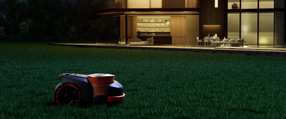 Navimow i110E robot lawn mower on dark green garden grass.