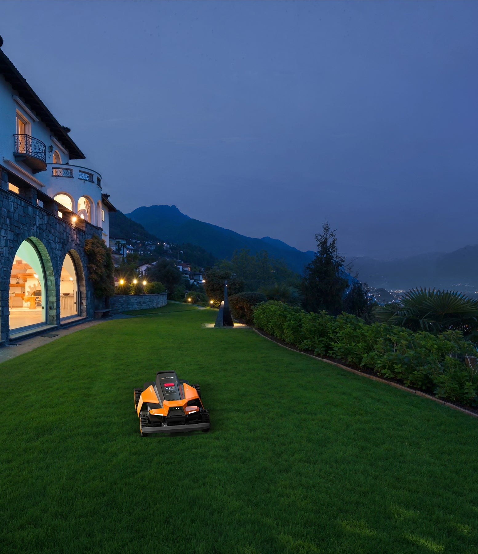 Navimow i110E robot lawn mower mows grass near the villa.