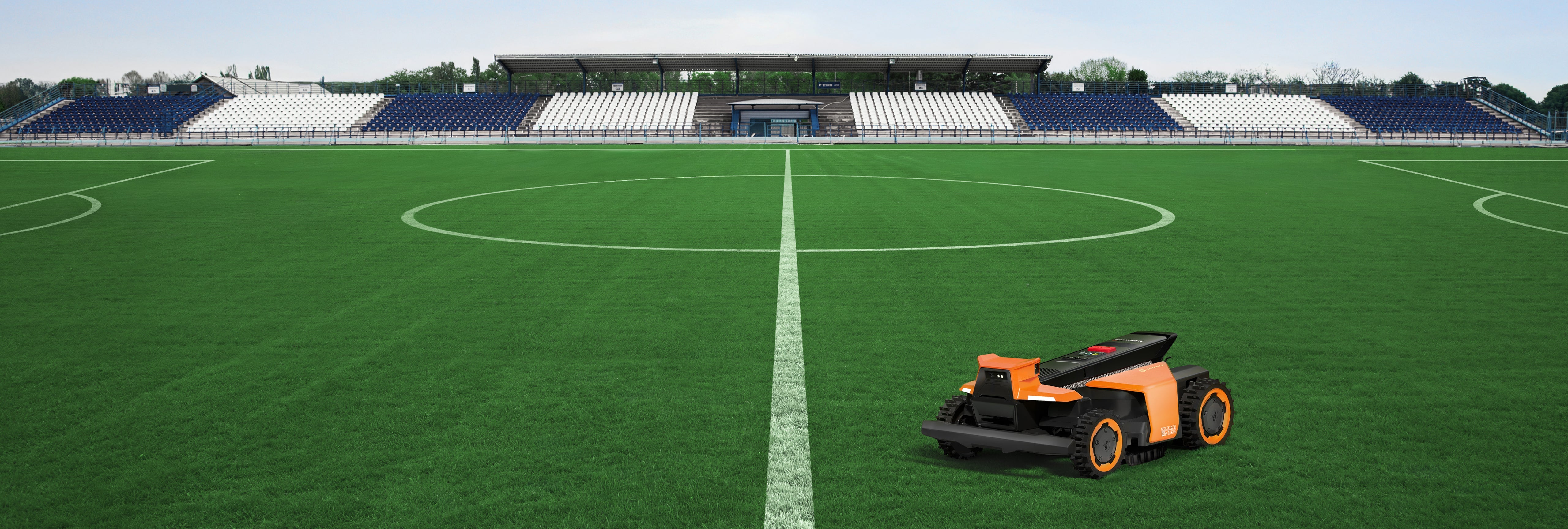 Navimow i110N robot lawn mower on a green soccer field.