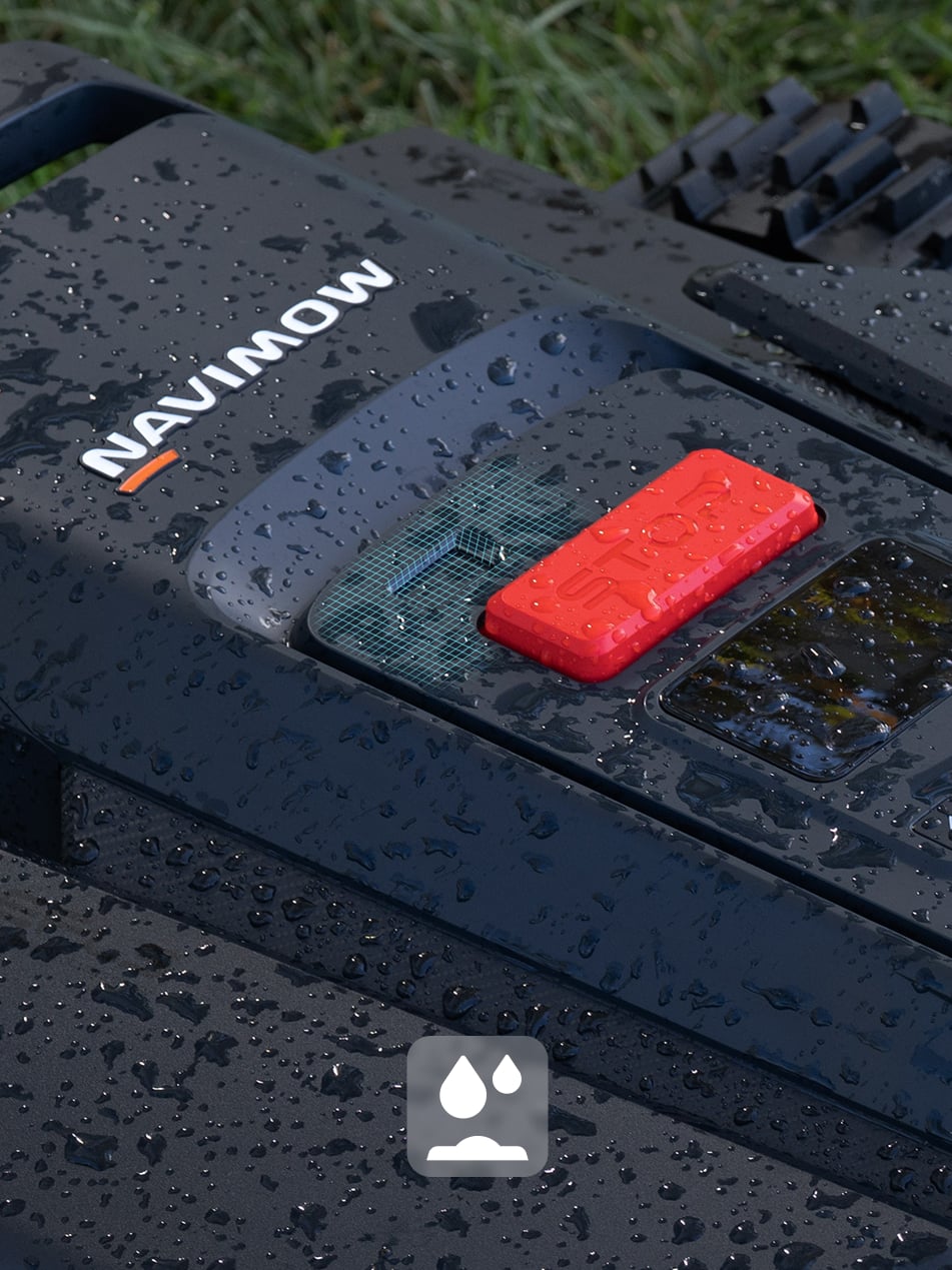 Navimow i110N robot lawn mower sits outdoors in the rain.