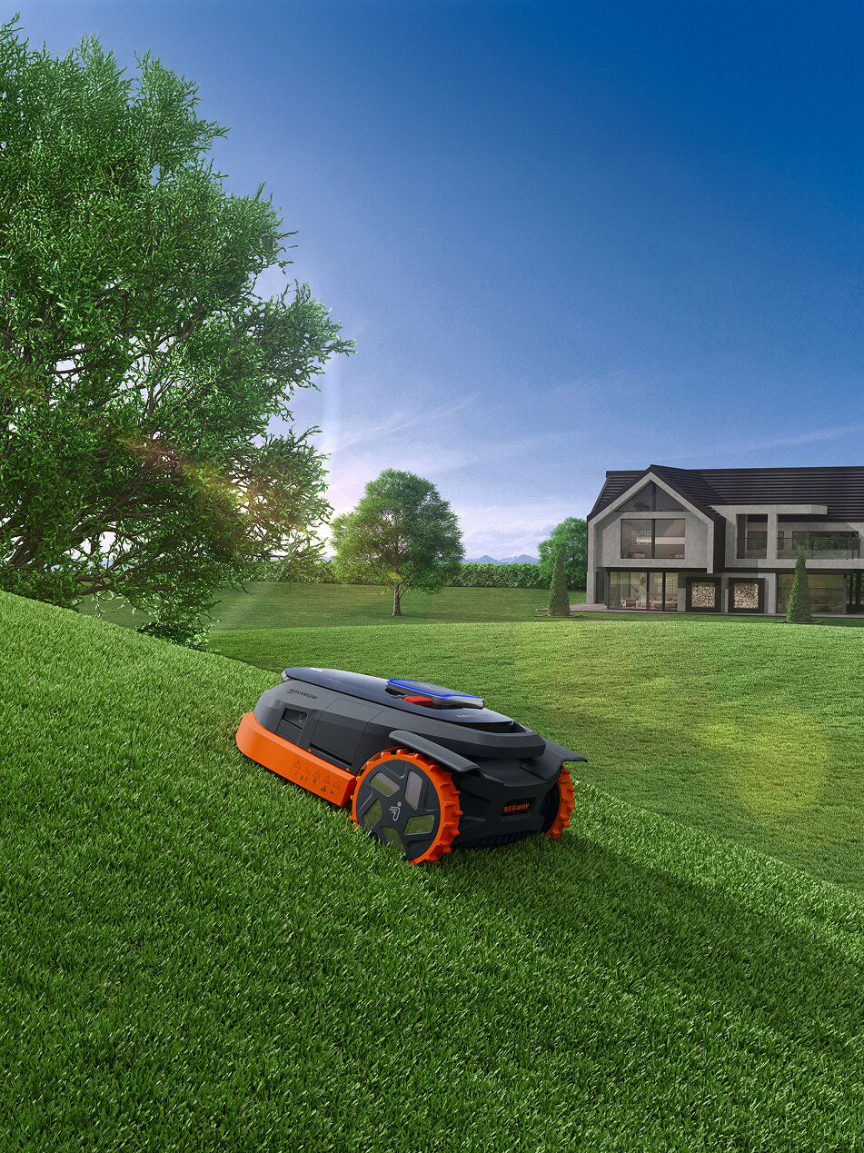 Segway Navimow robot lawn mower mows the lush green hill.