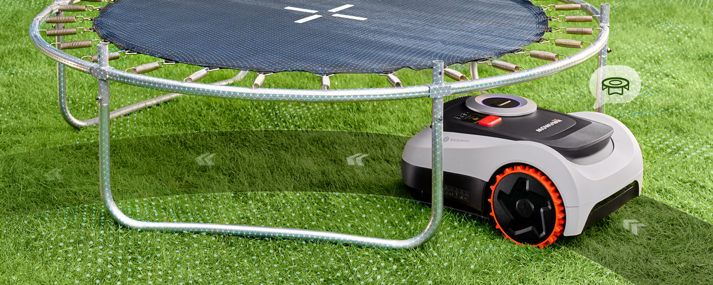 Segway Navimow robot lawn mower is cutting grass under trampoline.