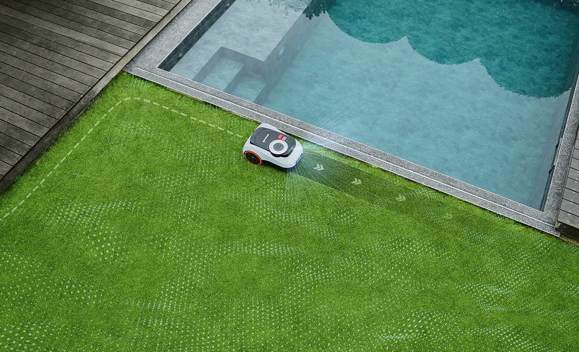 Segway Navimow i105E robot lawn mower mows lawn by pool.