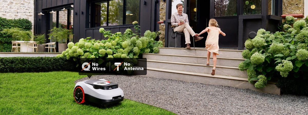 Navimow i110N robot lawn mower mows grass in the yard.