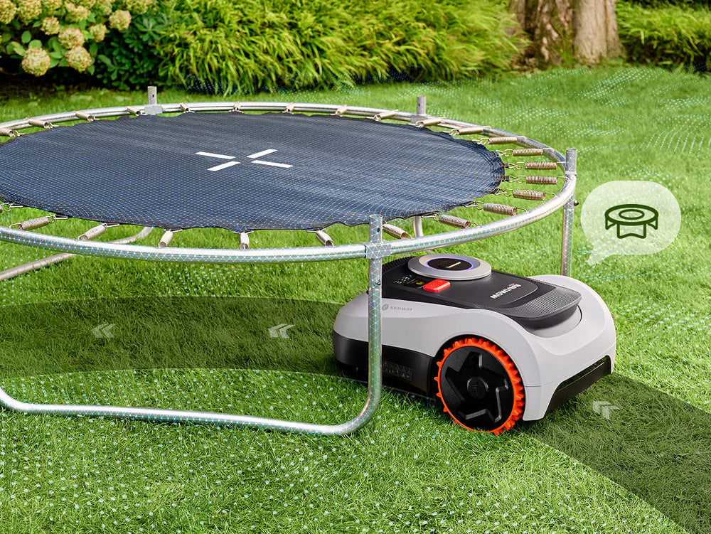 Segway Navimow i110N robot lawn mower mows grass under trampoline.