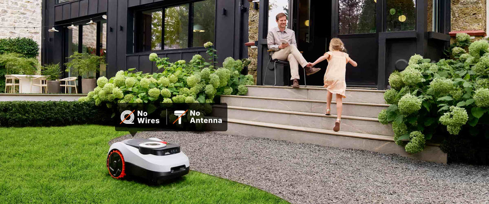 Navimow i110N robot lawn mower mows grass near the house.