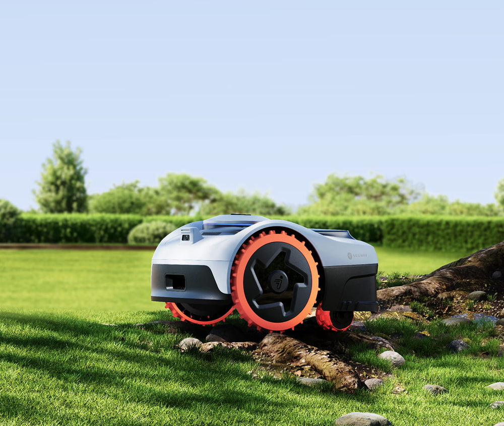 Segway Navimow i110N robot lawn mower mows the lush grass.