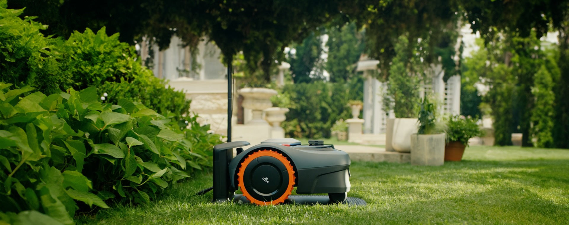 The Navimow i105E robot lawn mower stands on green grass.