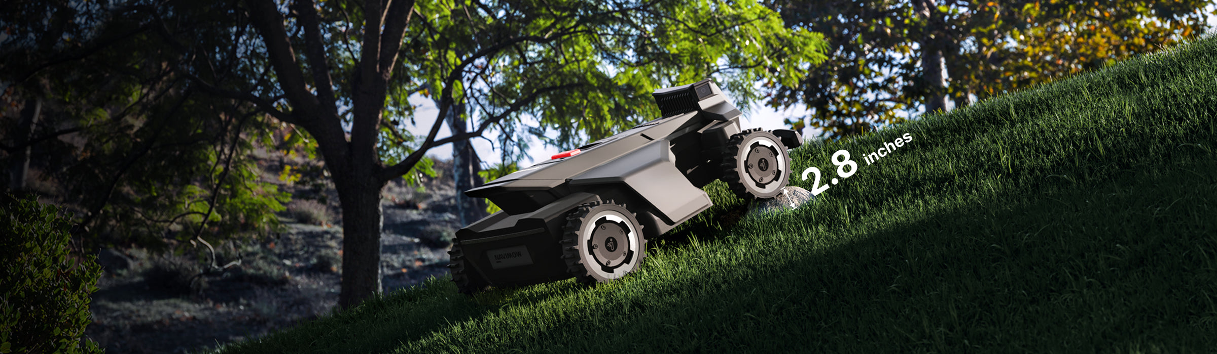 Navimow i110N robot lawn mower climbing up a steep hill.