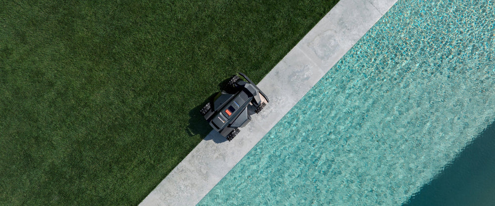 Navimow i105E robot lawn mower is on a pool edge.